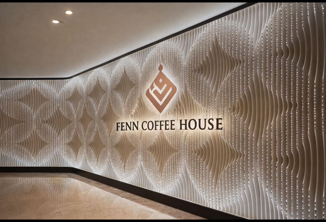 Fenn Coffee House rose-gold signage on a textured cream wall